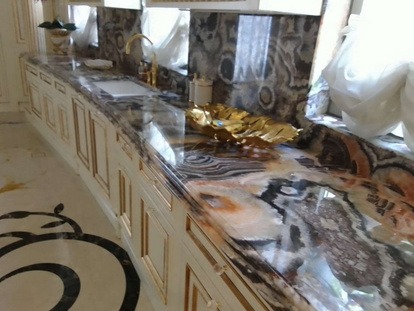 Fusion WOW quartz bathroom vanity countertop polished by MarblePro — luxury villa bathroom in Dubai with gold fixtures
