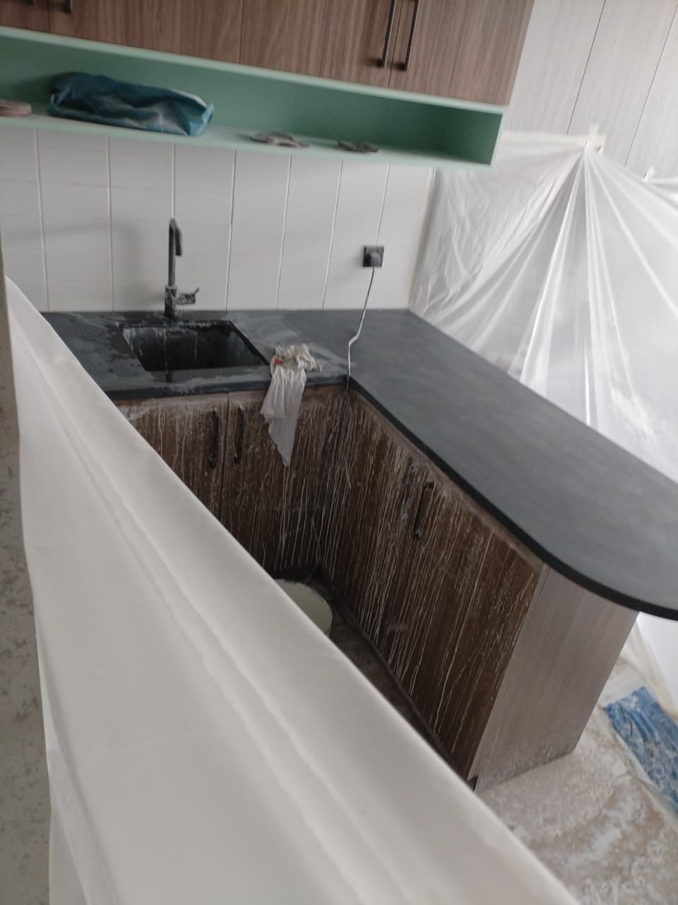 Dark grey granite kitchen countertop polished by MarblePro — professional countertop restoration in Dubai apartment