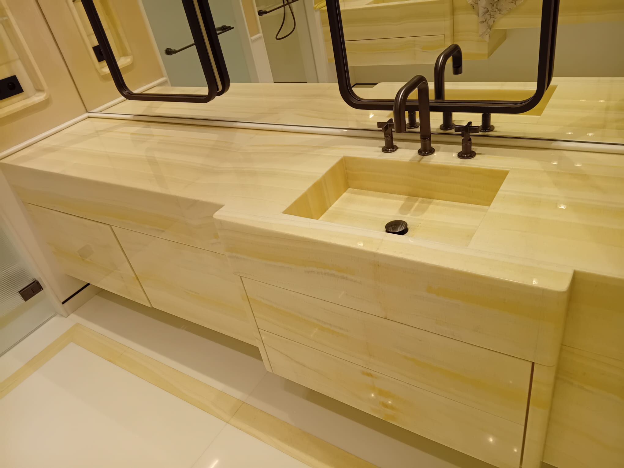 Honey onyx bathroom vanity polished to a translucent high-gloss finish by MarblePro — luxury bathroom in Dubai, UAE